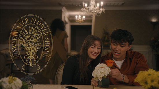 Man and Woman putting flowers in vase at Sweetwater Flower Shop