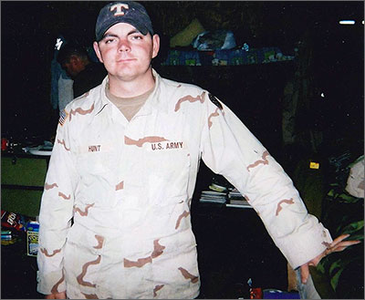 Sergeant Joey Hunt in uniform standing inside military barracks